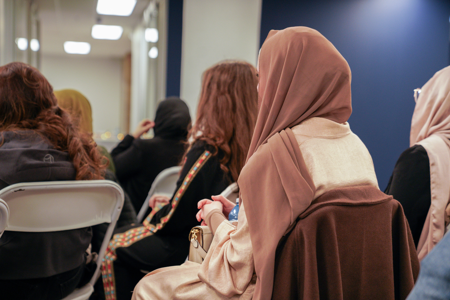 People sitting and listening as a speaker gives a talk