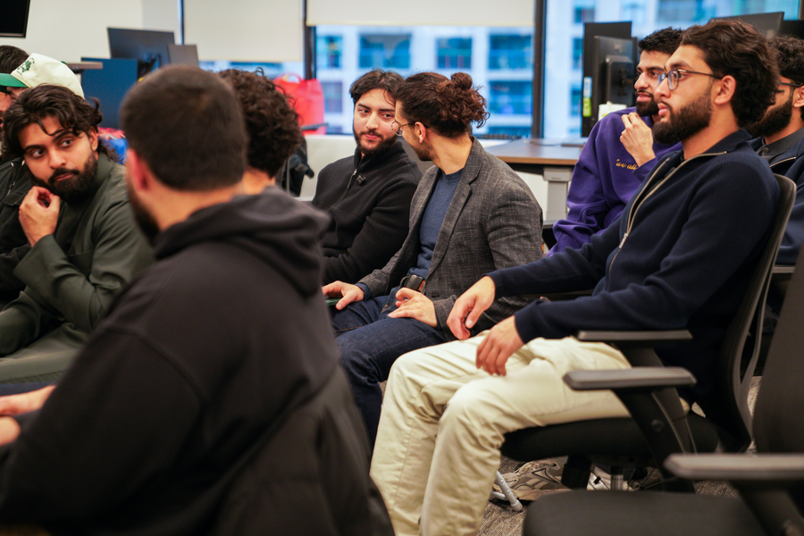 People sitting and listening as a speaker gives a talk