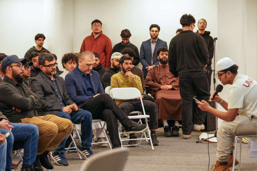 People sitting and listening as a speaker gives a talk