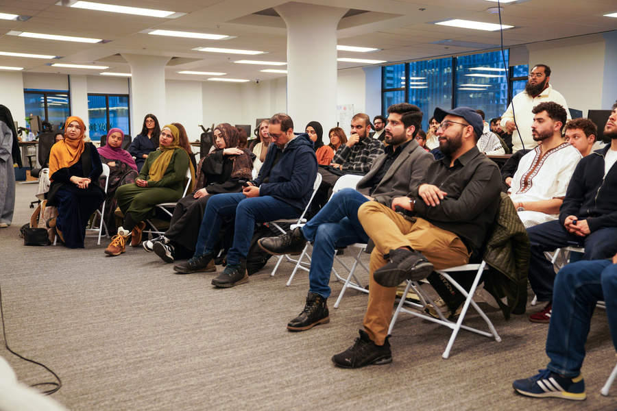 People sitting and listening as a speaker gives a talk