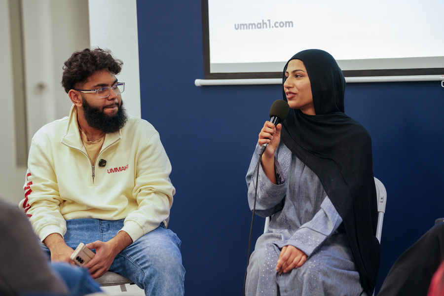 People sitting and listening as a speaker gives a talk